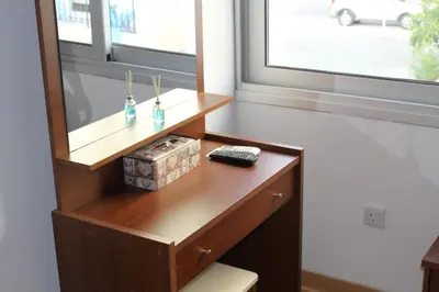 a wooden desk in a room with a window at Eclectic Business & Leisure in Nicosia