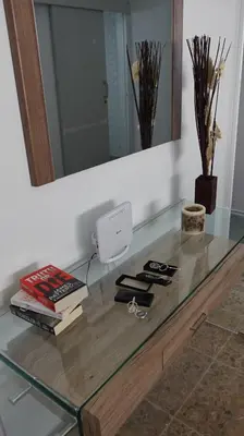 a glass table with books on it with a mirror at Eclectic Business & Leisure in Nicosia