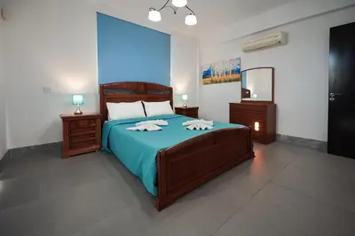 a bedroom with a bed with two towels on it at Beach Front Bella Vista by Ezoria Villas in Protaras