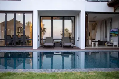 a villa with a swimming pool and a house at Balinese in Ayia Napa