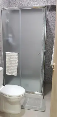 a bathroom with a toilet and a glass shower at Sunny Napa Apartments in Ayia Napa