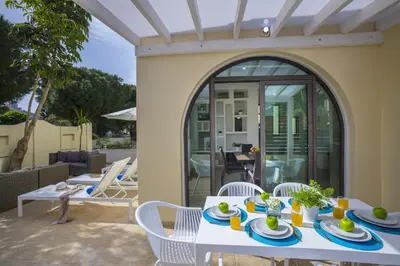 a table and chairs on a patio with a table and chairs at Villa Mylos 8 in Protaras