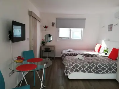 a small room with two beds and a table at Chicos Studios in Ayia Napa