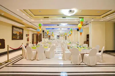 a banquet hall with white tables and chairs and balloons at Semeli Hotel in Nicosia