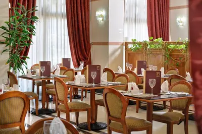 a dining room with tables and chairs in a room at Semeli Hotel in Nicosia