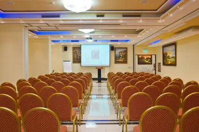a lecture hall with chairs and a screen at Semeli Hotel in Nicosia