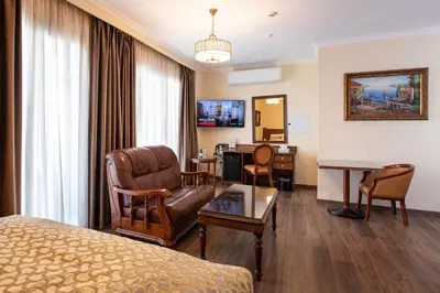 a hotel room with a bed and a living room at Semeli Hotel in Nicosia