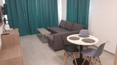 a living room with a couch and a table at Manoli Apartments in Ayia Napa