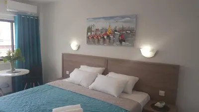 a bedroom with a bed and a painting on the wall at Manoli Apartments in Ayia Napa