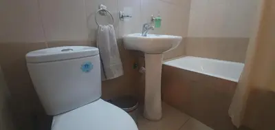 a bathroom with a white toilet and a sink at Vasilas Holiday Apartment #1 in Larnaka