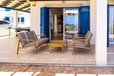 a pair of chairs and a table on a patio at Phaedrus Living: Seaside Luxury Villa Anafi in Paralimni