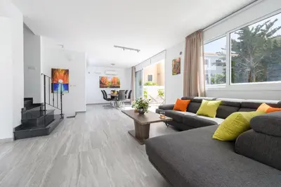 a living room with a couch and a tv at Green Bay Villa #13 in Protaras