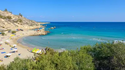 a group of people on a beach with the ocean at Green Bay Villa #13 in Protaras