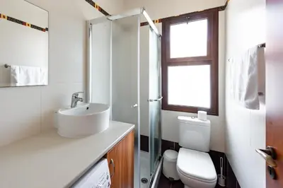 a bathroom with a toilet and a sink and a shower at Sea Front Costa Blu by Ezoria Villas in Ayia Napa