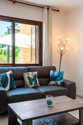 a living room with a couch and a table at Sea Front Costa Blu by Ezoria Villas in Ayia Napa
