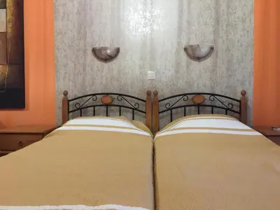 a bedroom with a bed with two pillows at Pomelo Apartments in Ayia Napa