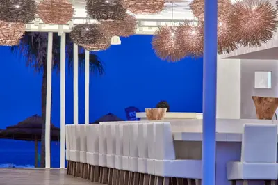 a lobby with blue walls and a table and chairs at So White Beach Resort in Ayia Napa