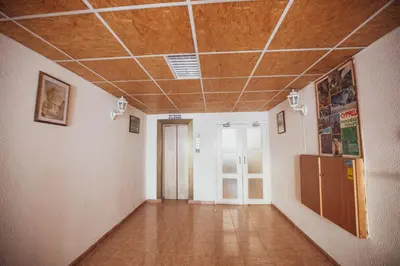 an empty room with a wooden ceiling and a hallway at Beach Haven in Larnaka