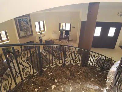 a spiral staircase in a house with a living room at Larnaca Mansion Ideal for 3 Families or more in Larnaka