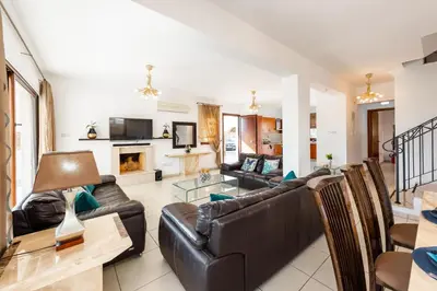 a living room with a couch and a table at Sea Front Oceanus H2 by Ezoria Villas in Ayia Napa