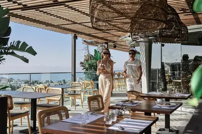 two women standing on the roof of a restaurant at Hotel Napa Suites (Adults Only) in Ayia Napa