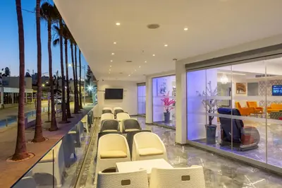 a conference room with chairs and palm trees at Milea Hotel in Ayia Napa
