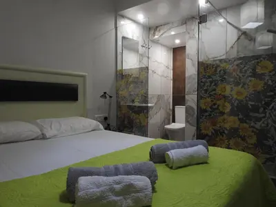 a bedroom with a large bed with two ottomans at Green Bay Penthouse 2 in Protaras