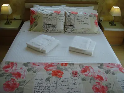 a bed with two towels on it with flowers on it at Athena Villa in Ayia Napa