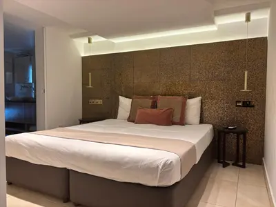 a bedroom with a large bed in a room at Tuck Inn in Larnaka