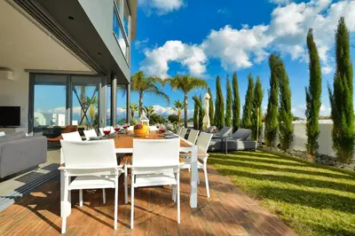 a dining room with a table and chairs on a patio at White Pearl Villas in Protaras