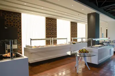 a restaurant with a buffet line with food on display at Rodon Hotel and Resort in Agros