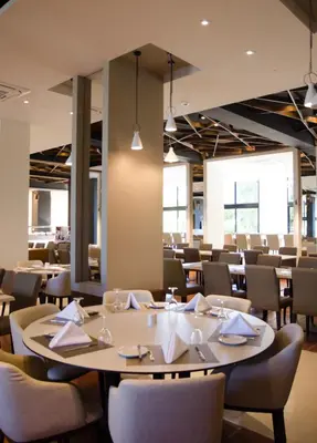 a dining room with a table and chairs at Rodon Hotel and Resort in Agros