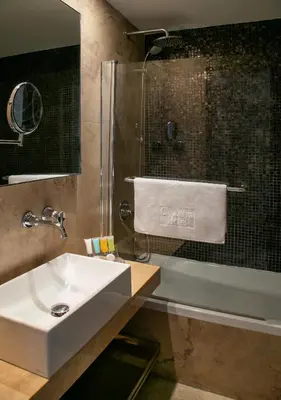a bathroom with a sink and a shower at Cleopatra Hotel in Nicosia