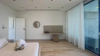 a bedroom with a bed and a large window at Vivo Mare 3 Bedroom Villas in Ayia Napa