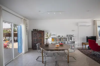 a living room with a table and chairs at Villa Serene in Ayia Napa