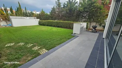 a backyard with a lawn and a yard with a yard at Beachfront Luxury Villa Tranquility in Ayia Napa