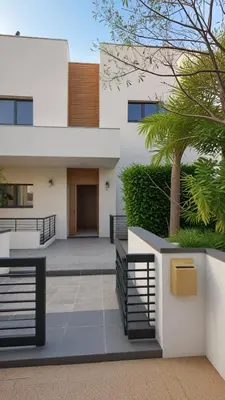 a white house with a palm tree in front of it at Beachfront Luxury Villa Tranquility in Ayia Napa