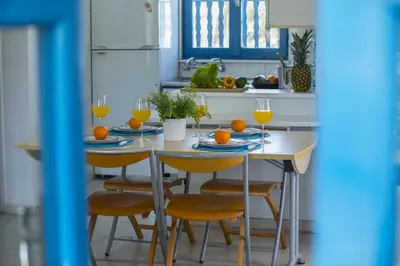 a kitchen with a table with oranges on it at Protaras Ayios Elias Suite in Protaras