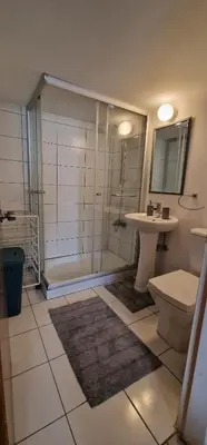 a bathroom with a shower and a toilet and a sink at Serenity by the sea in Larnaka