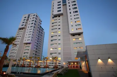 two tall buildings with a pool in front of them at Olympic Residence Deluxe Apartments in Limassol