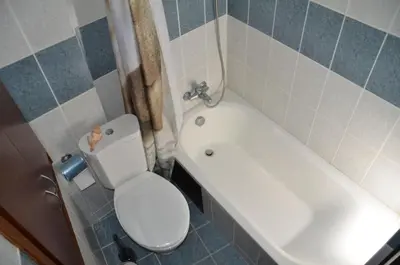 a bathroom with a toilet and a sink and a tub at Gold Mountain House in Moutoullas