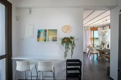 a dining room with white chairs and a table at Chris Le Mare Luxury Villa in Protaras