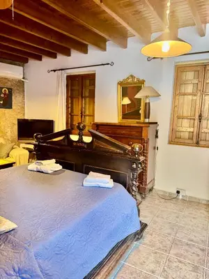 a bedroom with a large bed and a piano at Cornaro House in Arsos