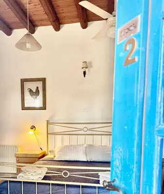 a bedroom with a bed with a blue surfboard at Cornaro House in Arsos