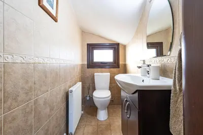 a bathroom with a toilet and a sink at Villa Joan in Ayios Theodhoros