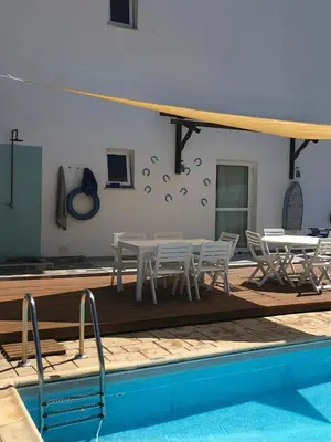 a patio with a table and chairs next to a pool at Villa Kiveli in Ayia Napa