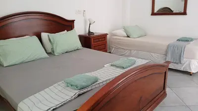 a bedroom with two beds with green towels on them at Villa Kiveli in Ayia Napa