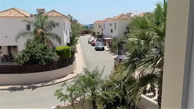 a view of a street with houses and a car at Villa Kiveli in Ayia Napa