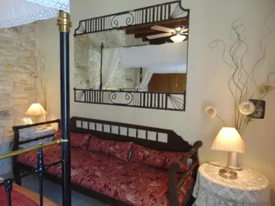 a bedroom with a bed and a large mirror at Charalambos Holiday Cottage in Kalavasos