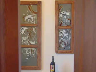a bottle of wine sitting next to a window at Charalambos Holiday Cottage in Kalavasos